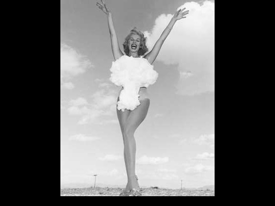 1950's era woman in bathing suit shaped like an atomic bomb's mushroom cloud