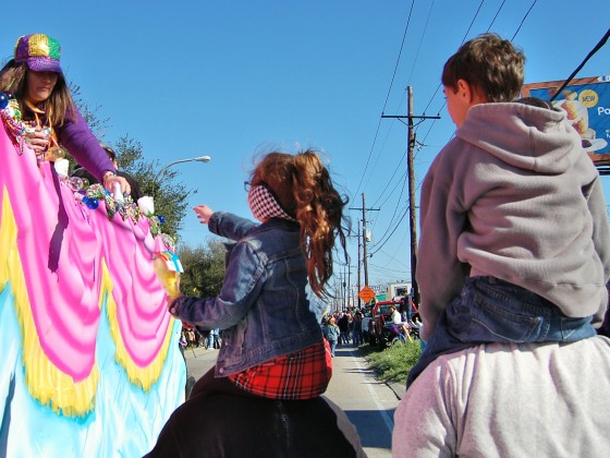 kids on piggyback getting beads & toys