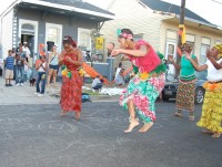 Dancers in Western Africa outfits perform.